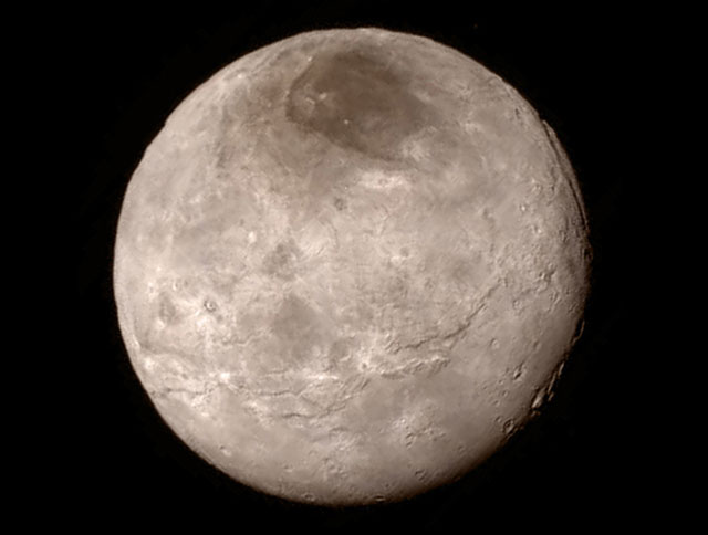 Latest image of Charon with its enigmatic dark polar cap, and a stupendous fracture system running near to its equator (image: Nasa)