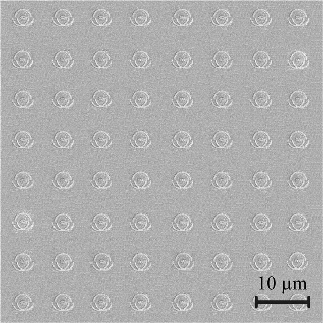 The nanophotonic chip magnified 2 000 times. Each indentation on the image is a single unit of the chip, like a single pixel in a display panel, made up of semi-circle nano-grooves and nano-apertures engraved in a metallic film