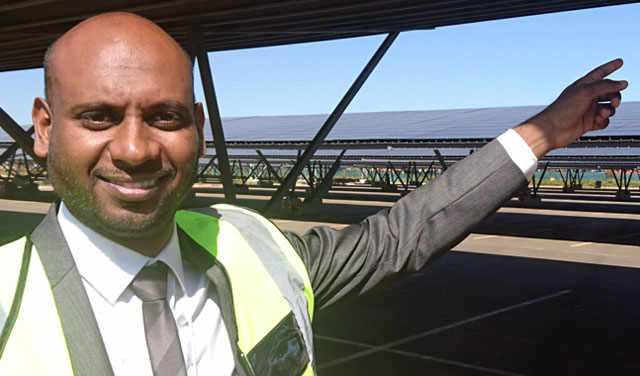 Telkom's Praven Naidoo in front of a section of the solar PV panels