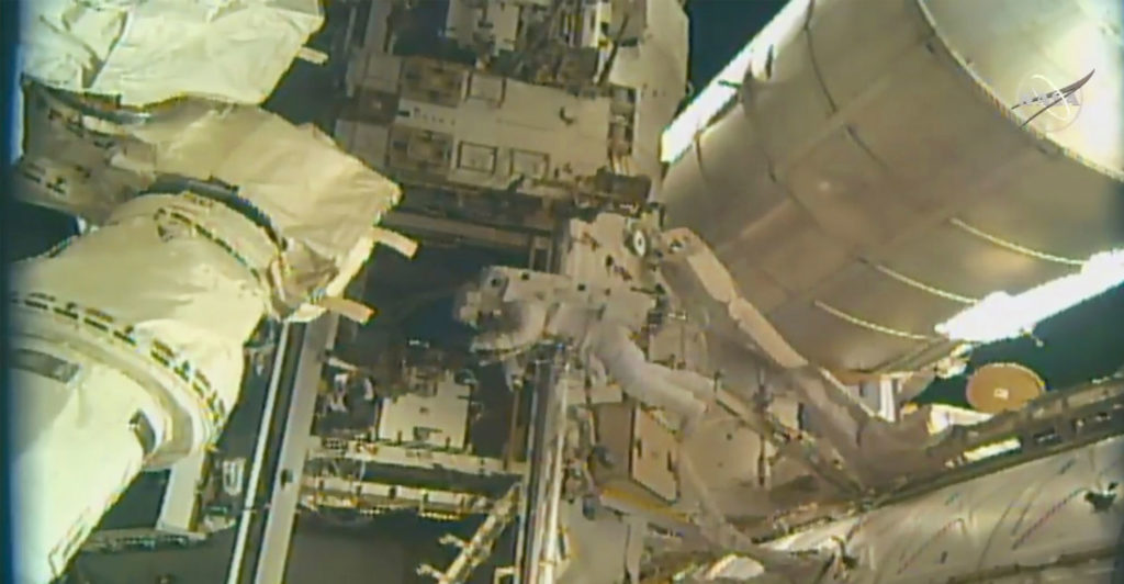 Spacewalking astronauts add parking spot to space station
