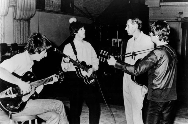 The Beatles in the recording studio with producer George Martin in 1966. Capitol Records
