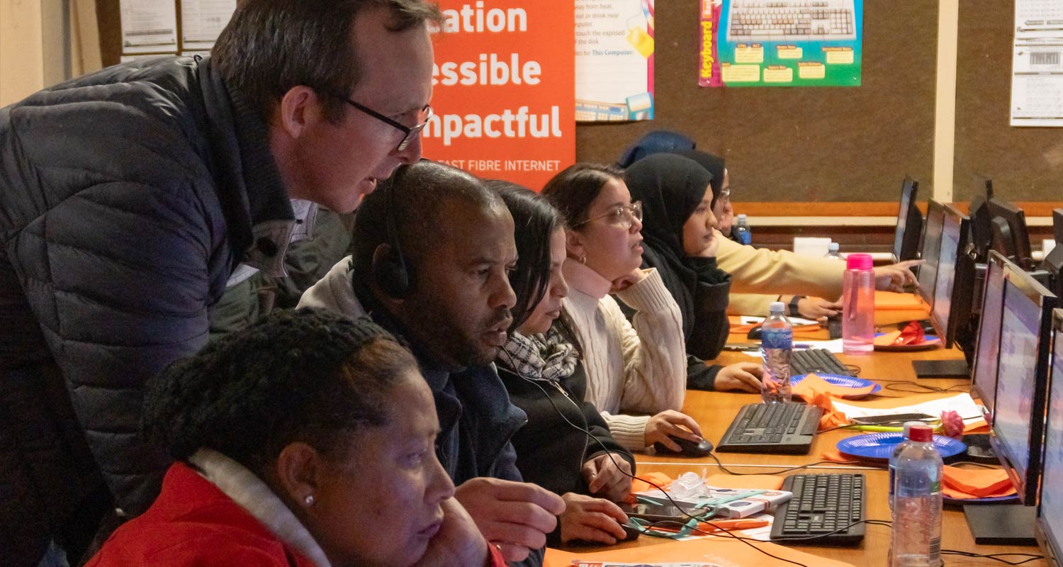 Educators receive expert guidance from David Campey of Coder Level Up as they dive into robotics training during Octotel's transformative initiative