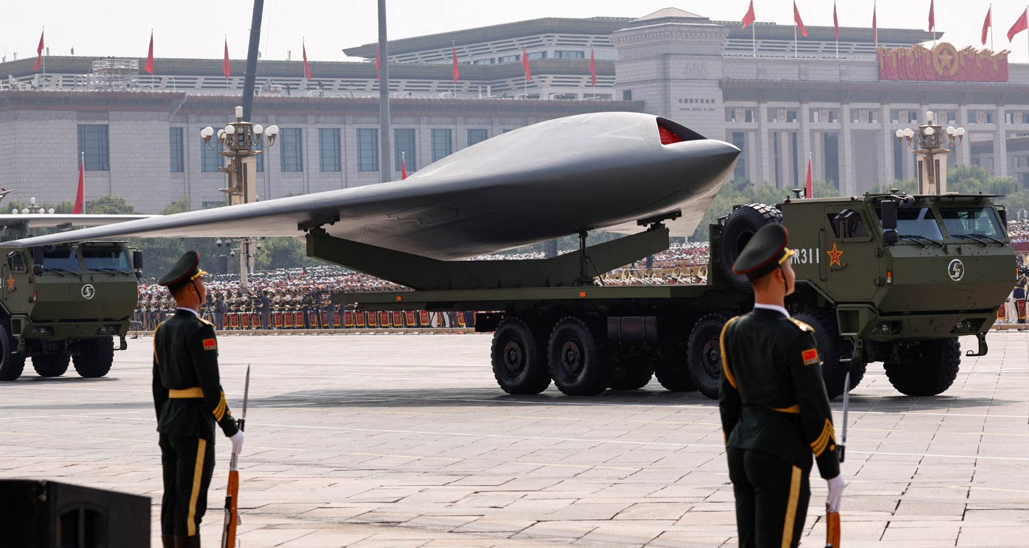 Members of the People's Liberation Army stand as unmanned operations group display a drone during a military parade to mark the 80th anniversary of the end of World War 2, in Beijing, China, 3 September 2025. Tingshu Wang/Reuters