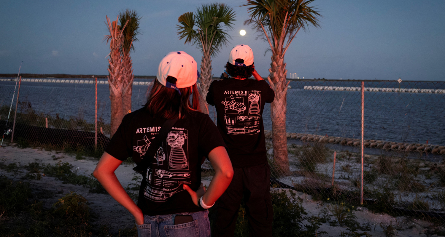 A man uses his phone to take photos of the moon after the launch of the next-generation moon rocket. Marco Bello/Reuters
