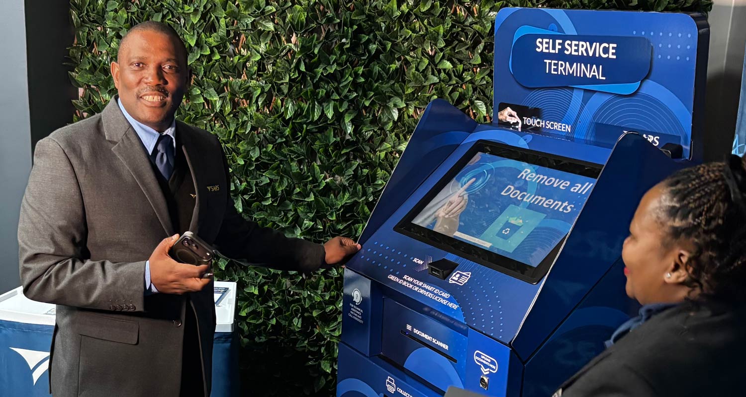Sars commissioner Johnston Makhubu, left, with a Sars self-service terminal