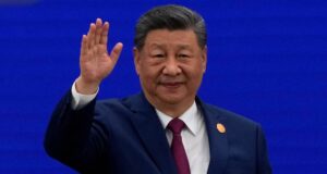 Xi pitches China as the world's AI liberator - Chinese President Xi Jinping waves as he arrives at the opening ceremony of the World AI Conference in Shanghai. Ng Han Guan/Reuters