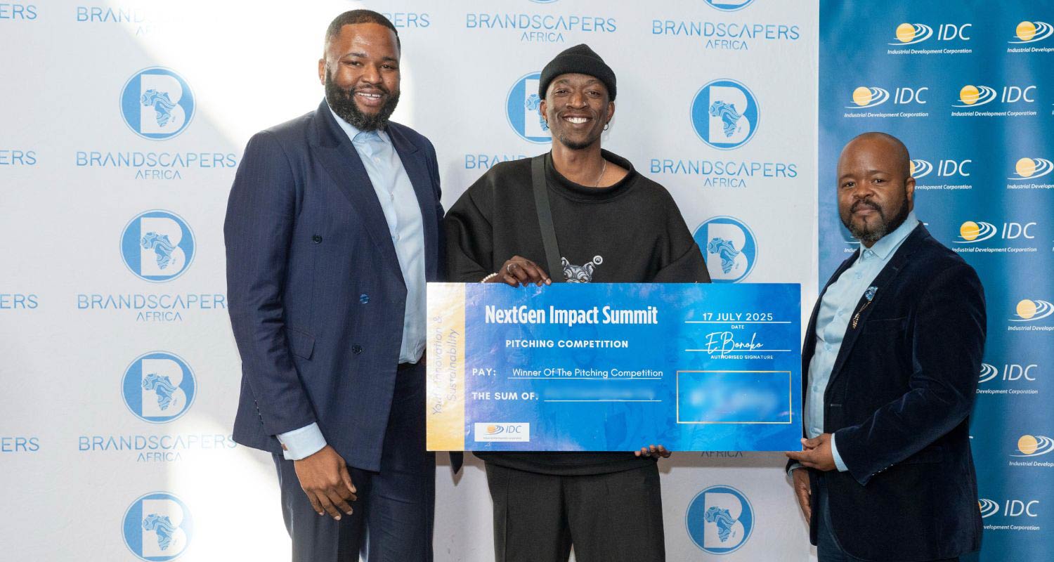 Brandscapers founder and marketing director Emmanuel Bonoko, left, and the IDC's Ivan Mathebula, right, present the pitching competition prize to the winner at the Next Gen Impact Summit